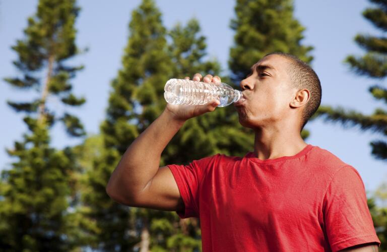 young man drinking water