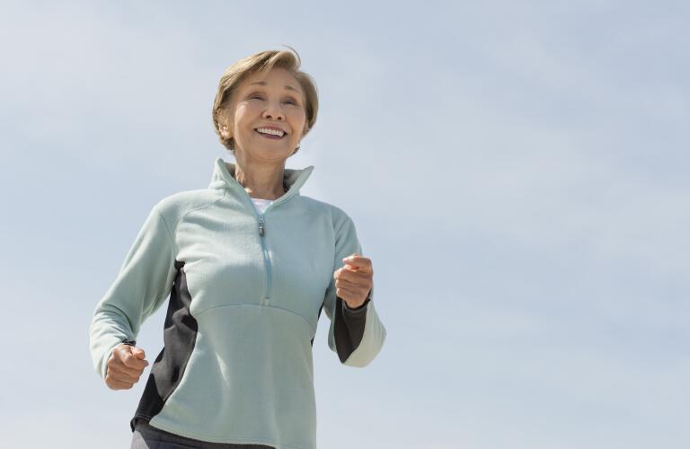 Middle-aged woman jogging outside
