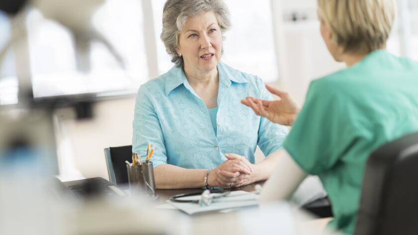 Doctor talking to patient in doctor's office