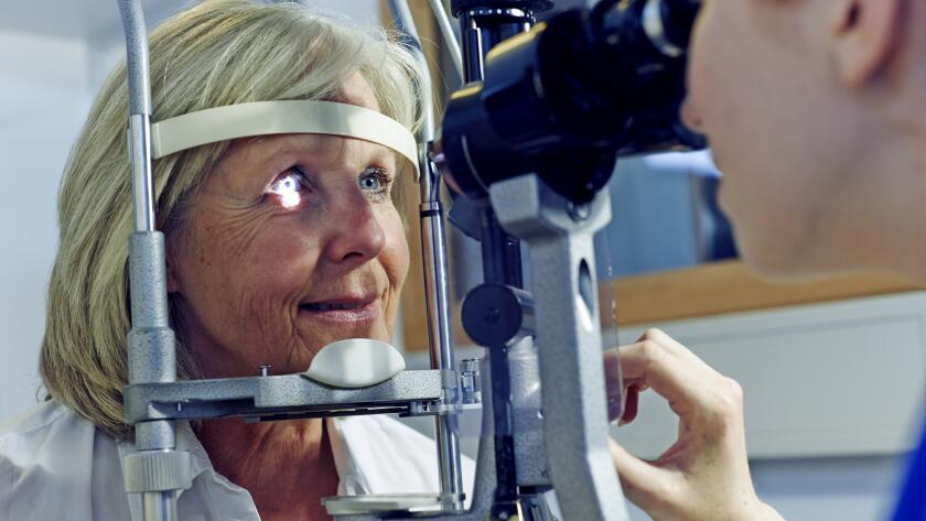 Female patient having eye tested in hospital