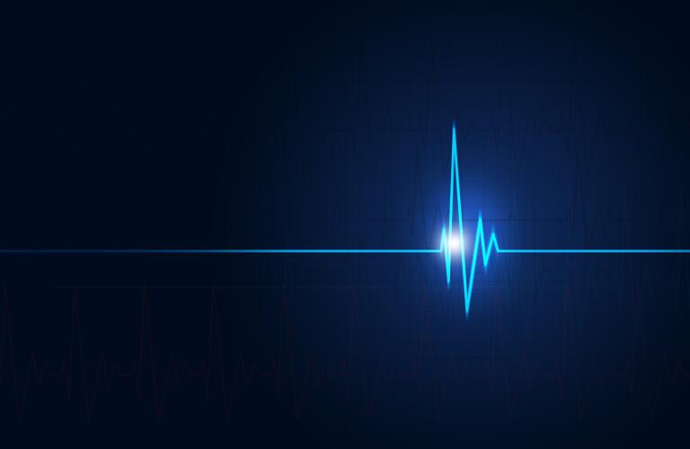 concept image of a heartbeat as seen by electrocardiogram on a medical blue background
