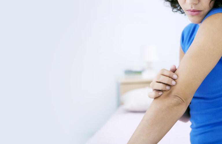 woman looking at psoriasis