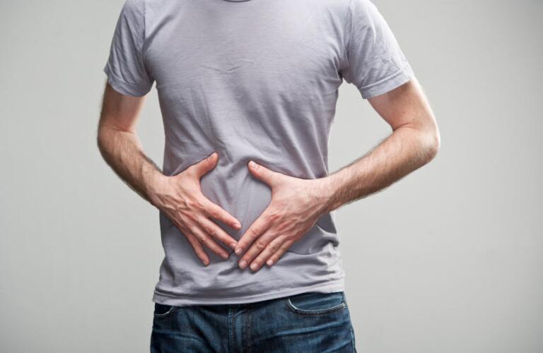 man holding stomach, stomach, bowel, ibs, sick
