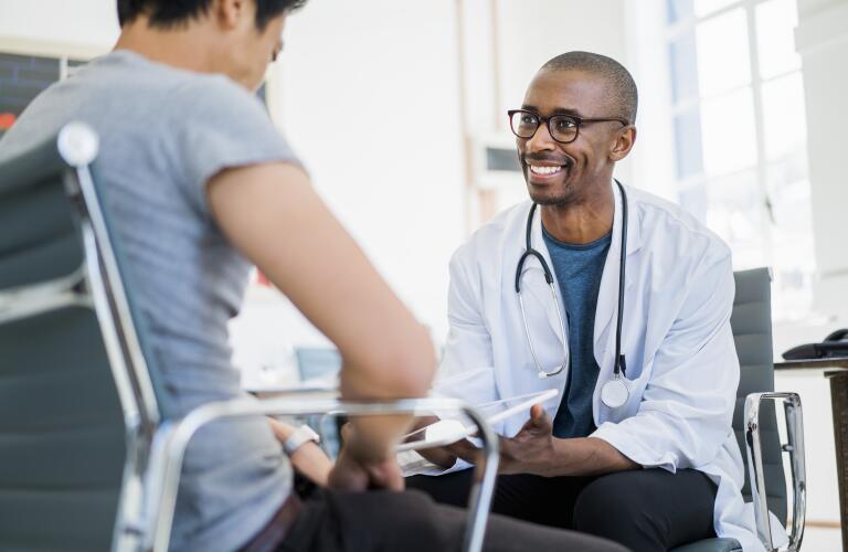 Doctor showing results to patient in hospital