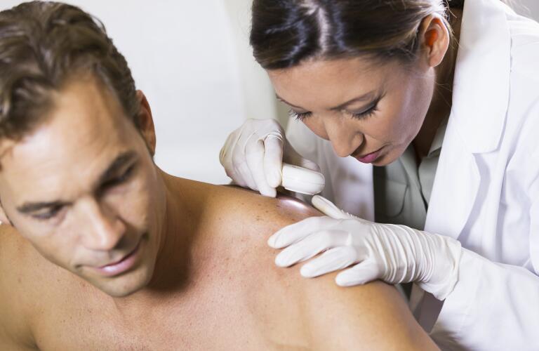 Doctor examining patient's back