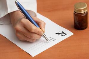Doctor filling out prescription